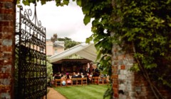 Bignor Park Weddings Greek Loggia through a gate