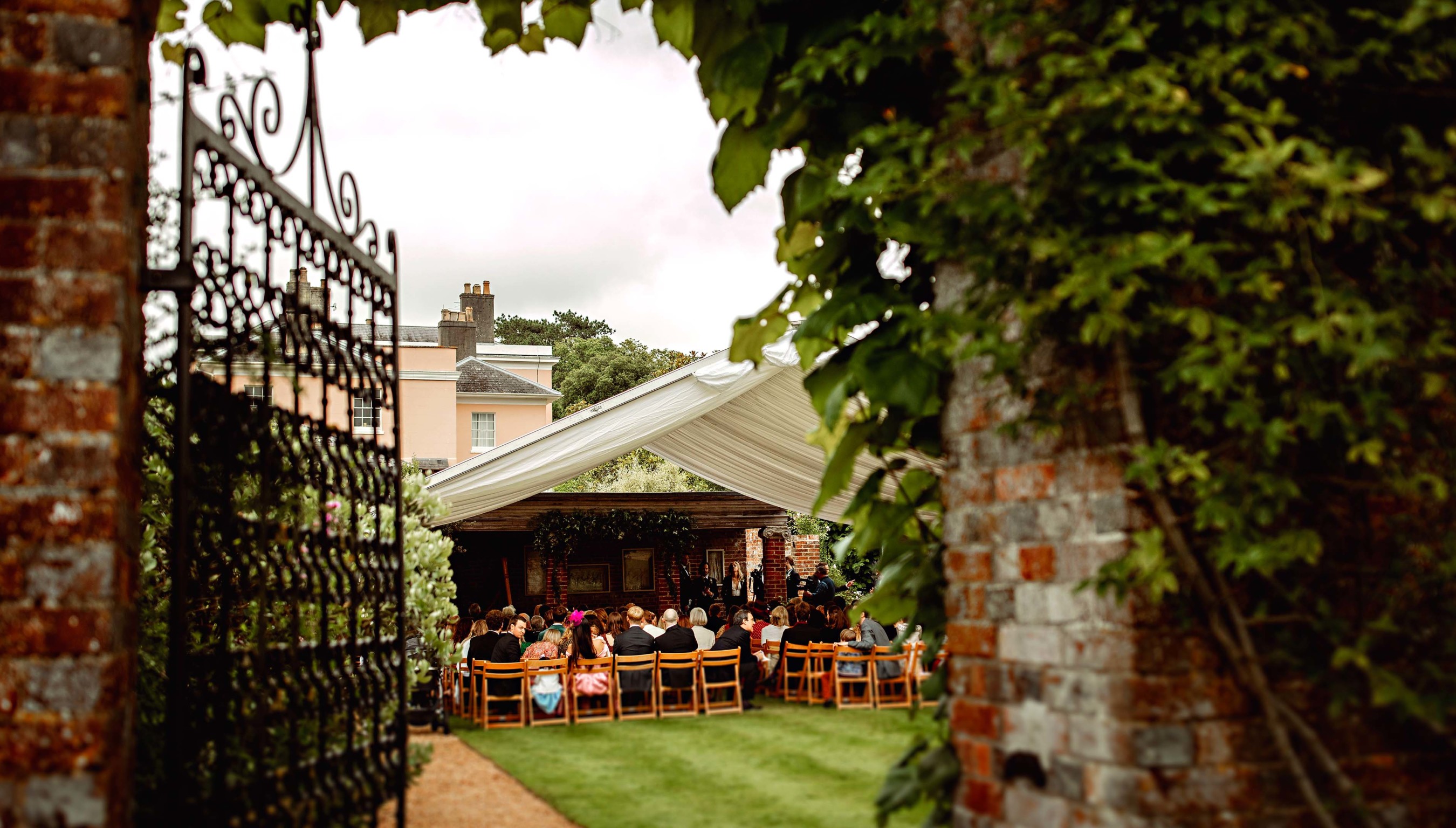 Bignor Park Weddings Greek Loggia through a gate