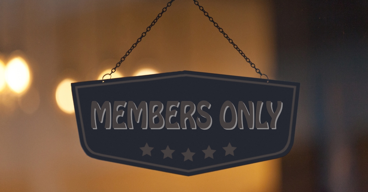 A black sign with "MEMBERS ONLY" and five stars hangs on a chain against a blurred background, suggesting exclusivity.