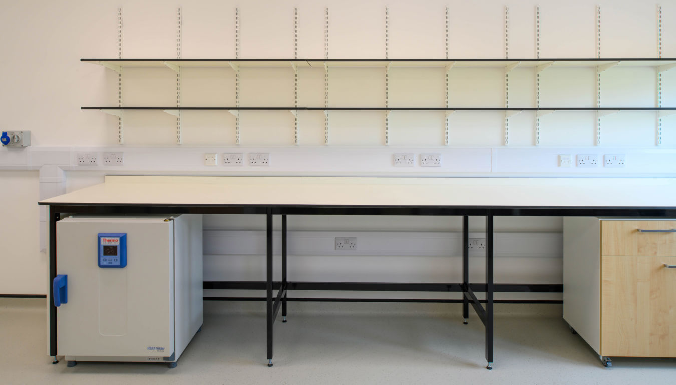 Laboratory workstation with shelving, integrated power outlets, and under-bench storage, designed by COEL for Transition Bio.