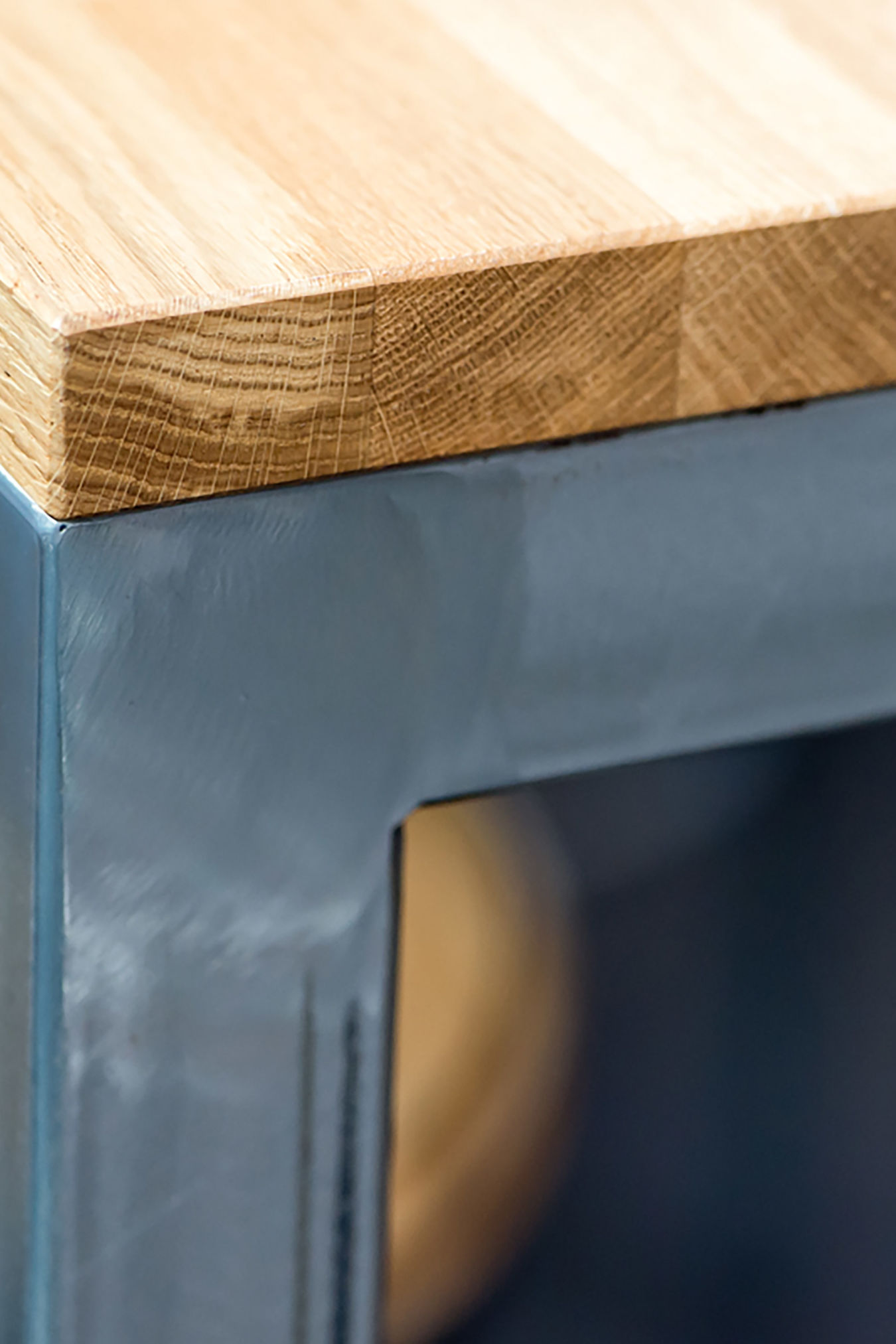 Close-up of industrial-style table with metal frame and wooden top, part of a COEL furniture installation for Jagex.