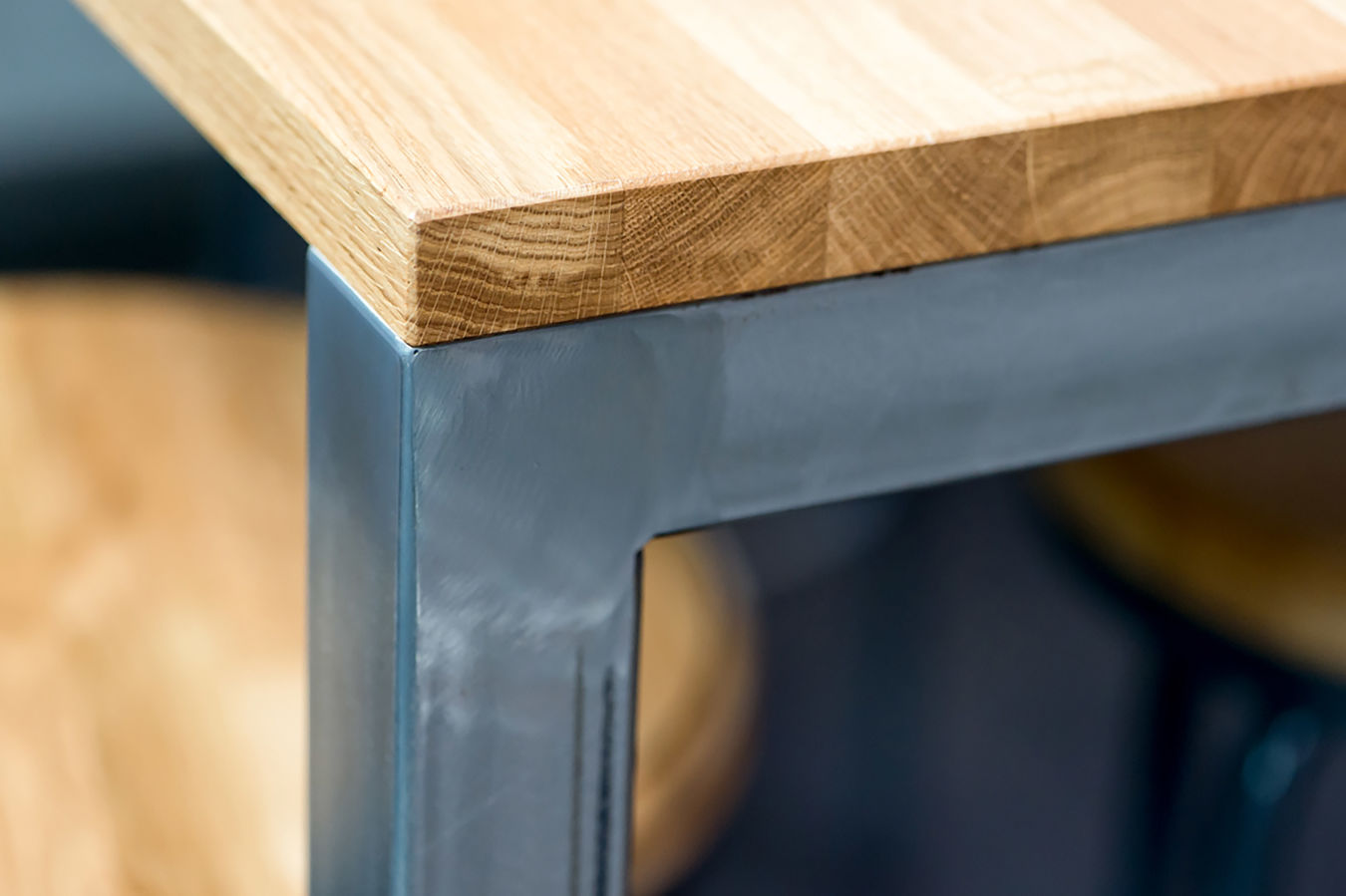 Close-up of industrial-style table with metal frame and wooden top, part of a COEL furniture installation for Jagex.