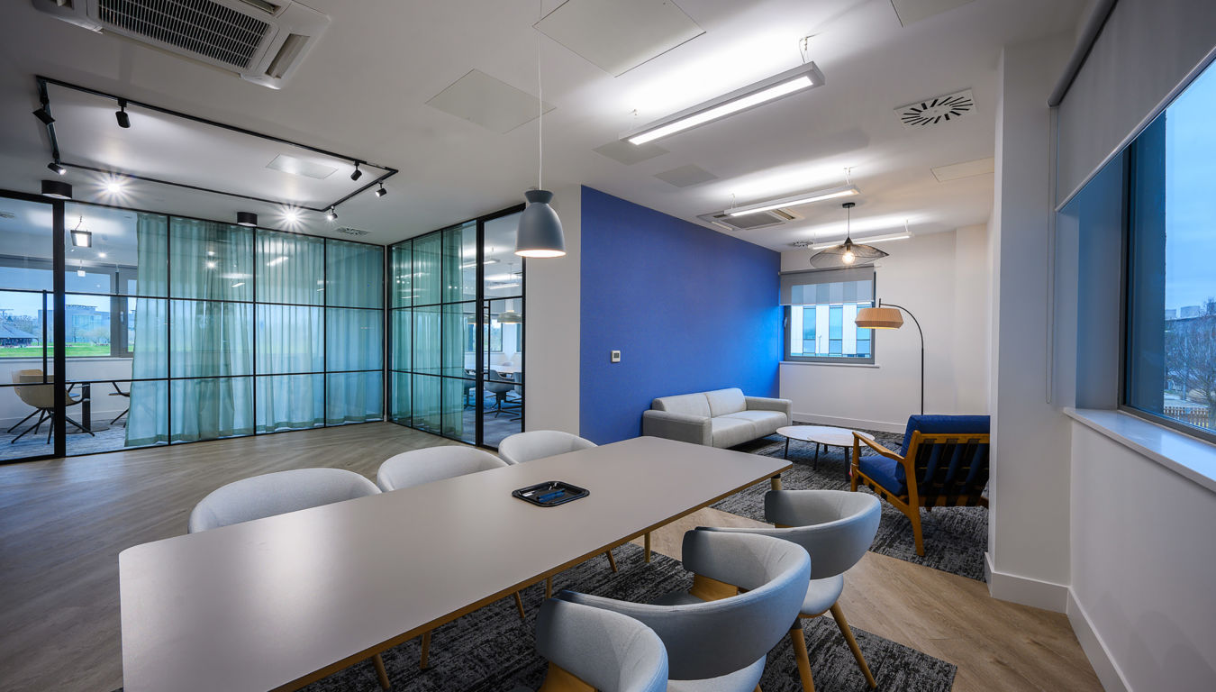 Contemporary meeting room with sleek furnishings, natural light, and wood accents, part of a COEL office furniture and fit-out project for BioMed Realty.