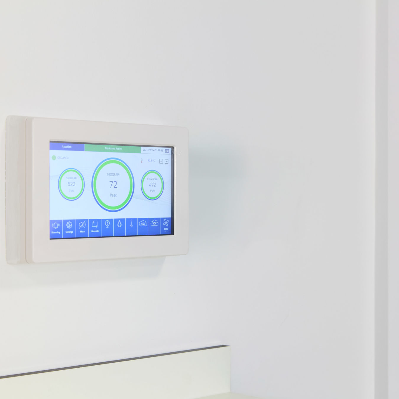 digital wall-mounted thermostat displays temperature and other climate control information on a touchscreen interface