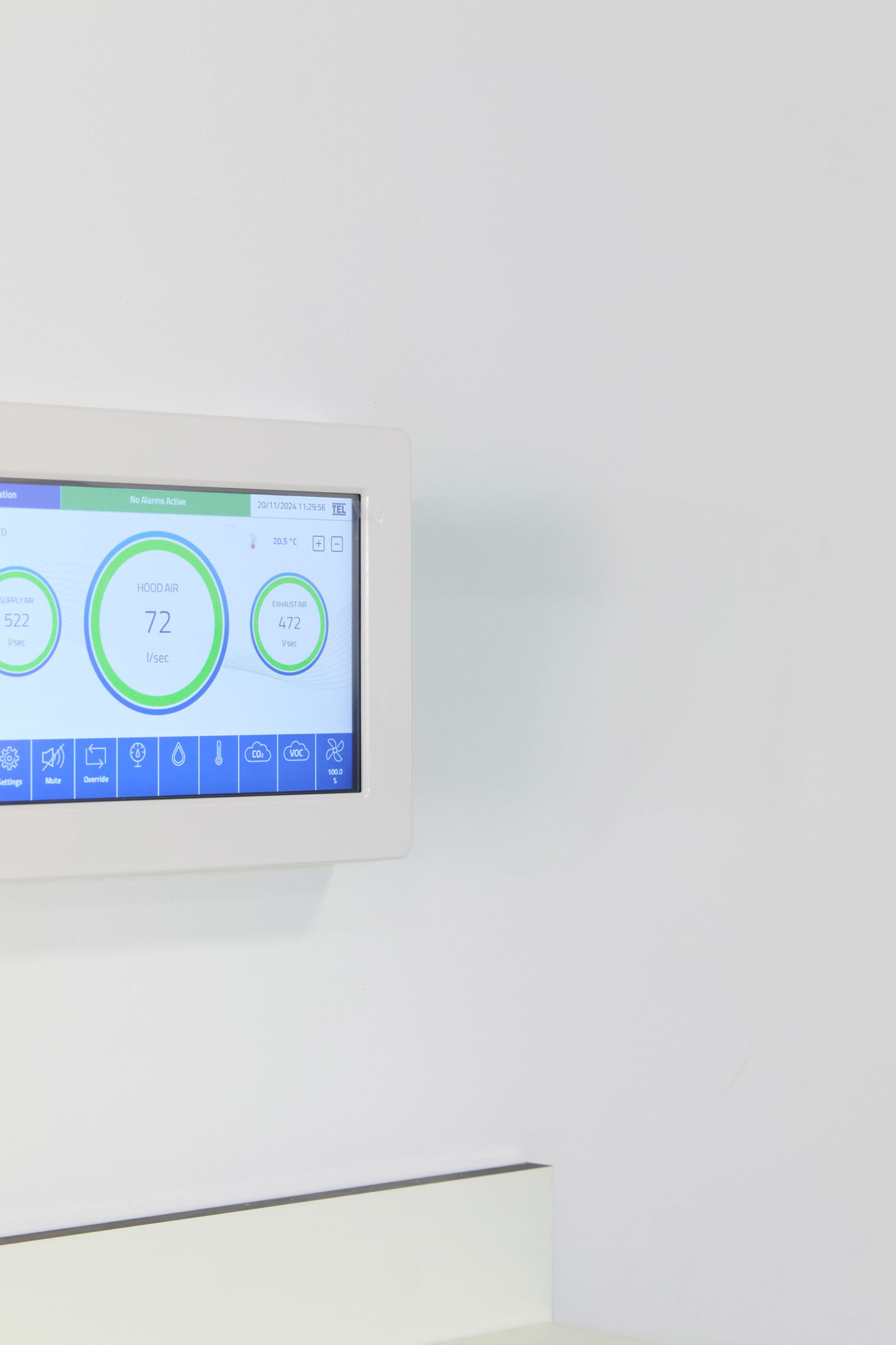 digital wall-mounted thermostat displays temperature and other climate control information on a touchscreen interface