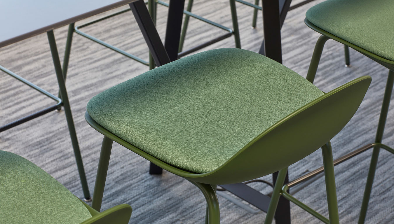 Close-up of modern green office chairs with metal frames, featured in a COEL office furniture installation.