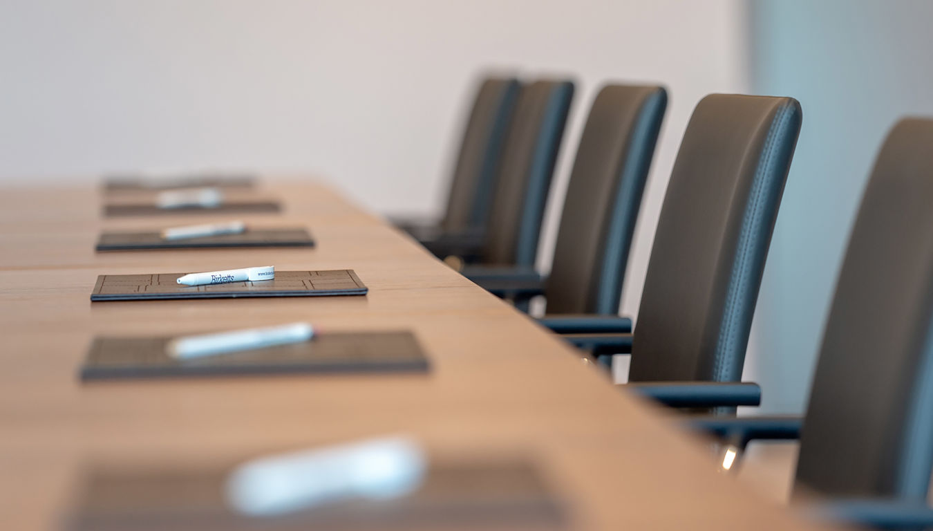 Boardroom setup with modern office chairs and neatly arranged stationery, part of a COEL office furniture installation project.