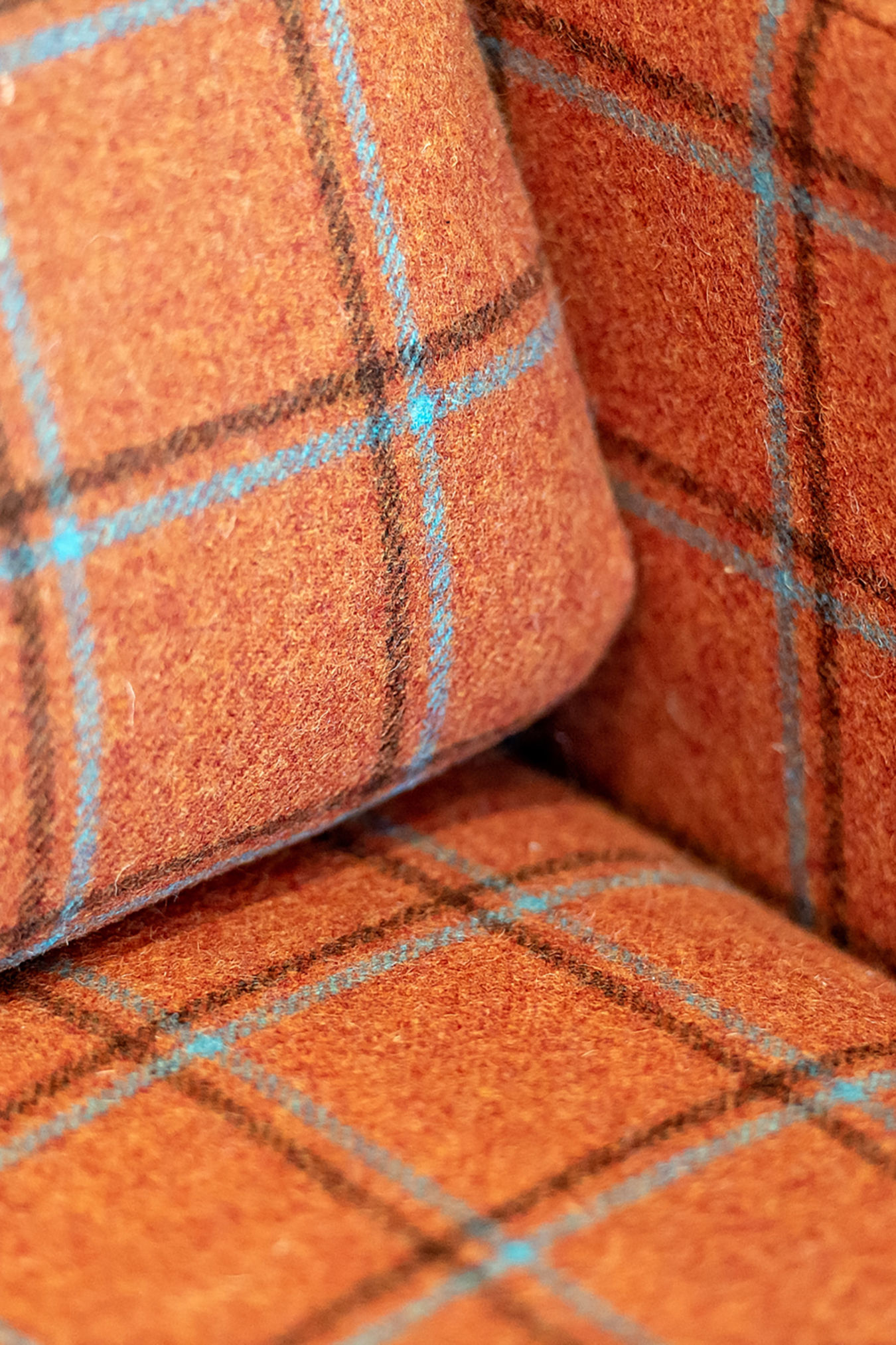 Close-up of orange plaid upholstered sofa fabric, featured in a COEL office furniture installation for Birketts in Ipswich.