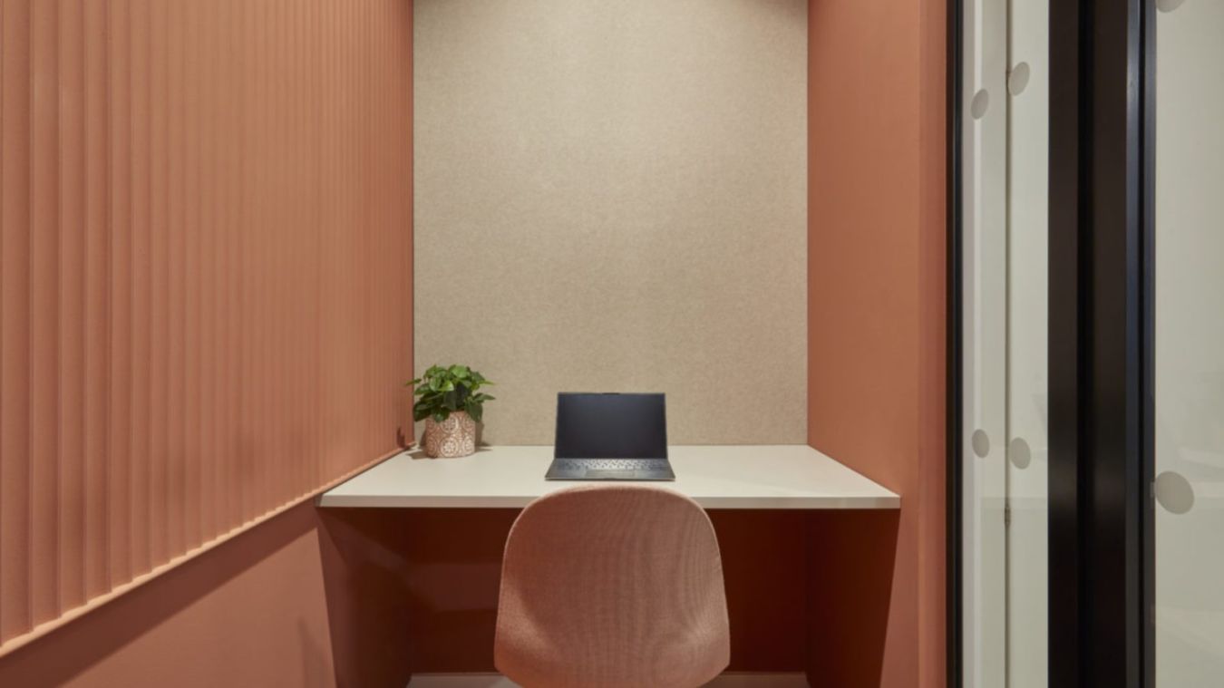 small office nook with a desk, chair, and a plant